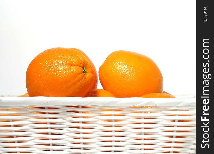 Oranges in white wicker basket. Oranges in white wicker basket