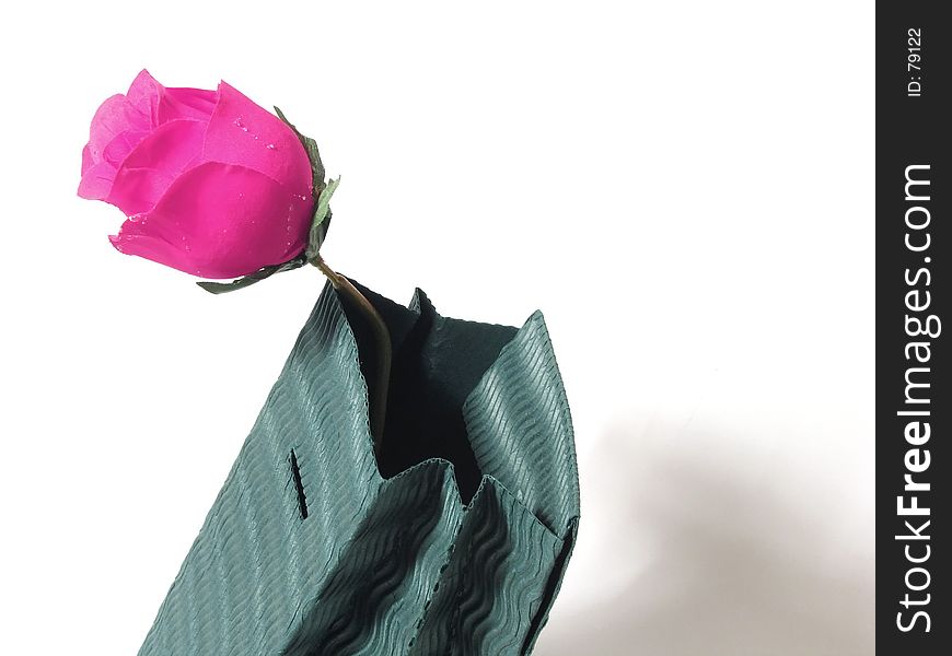 Green corrugated gift bag; hot pink rose. Green corrugated gift bag; hot pink rose