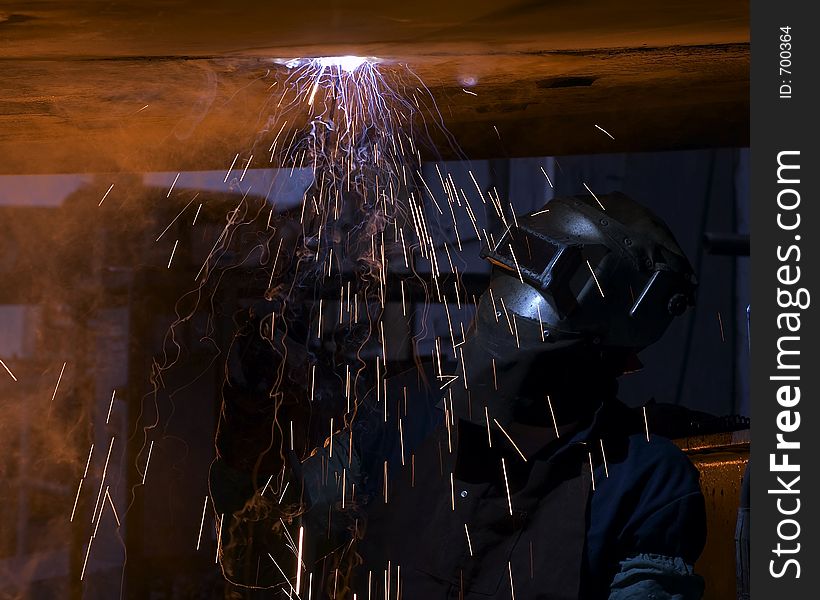 Welder making fire trails while welding