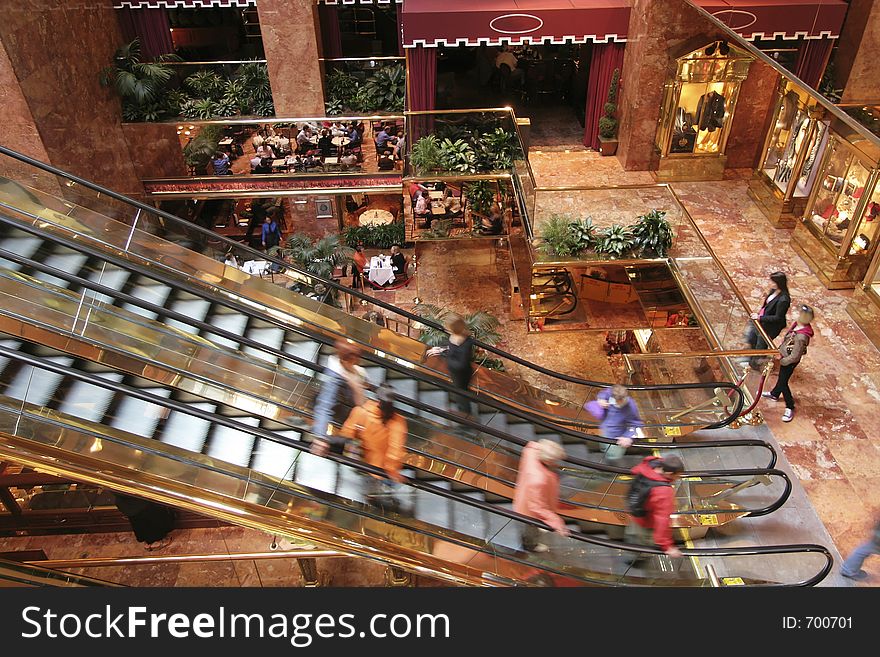 Lobby of an office building with escsalators and people