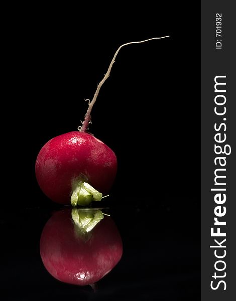 Red radish with reflex on black background