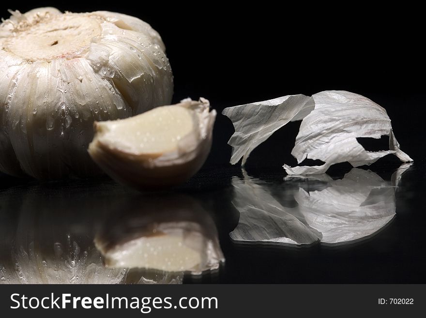 Macro of garlic with reflex on black background