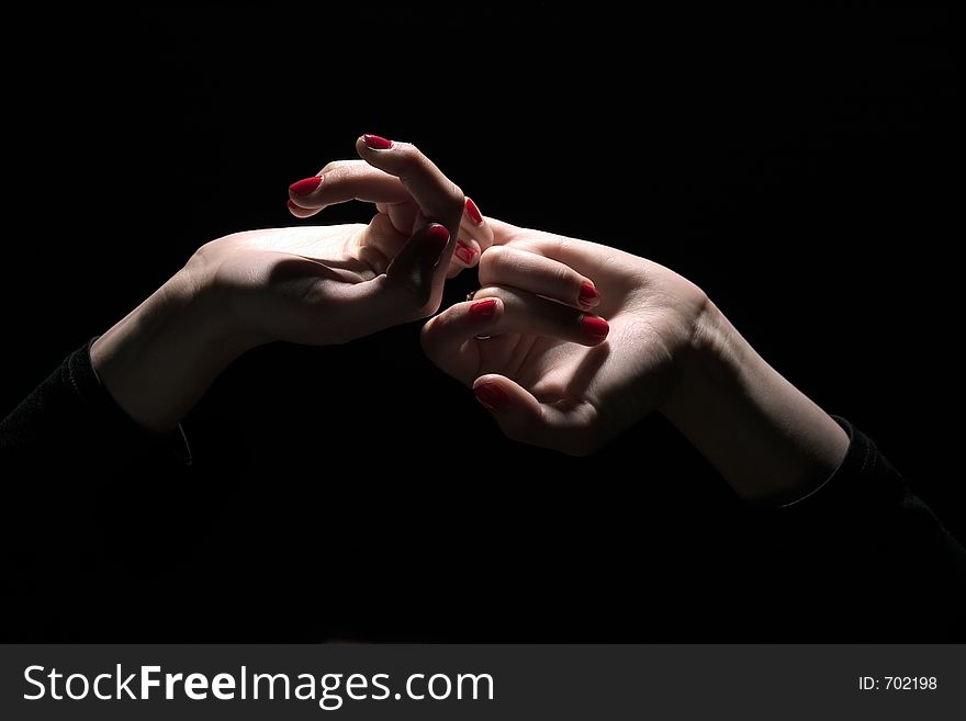 Tie palms with red nails on dark background. Tie palms with red nails on dark background