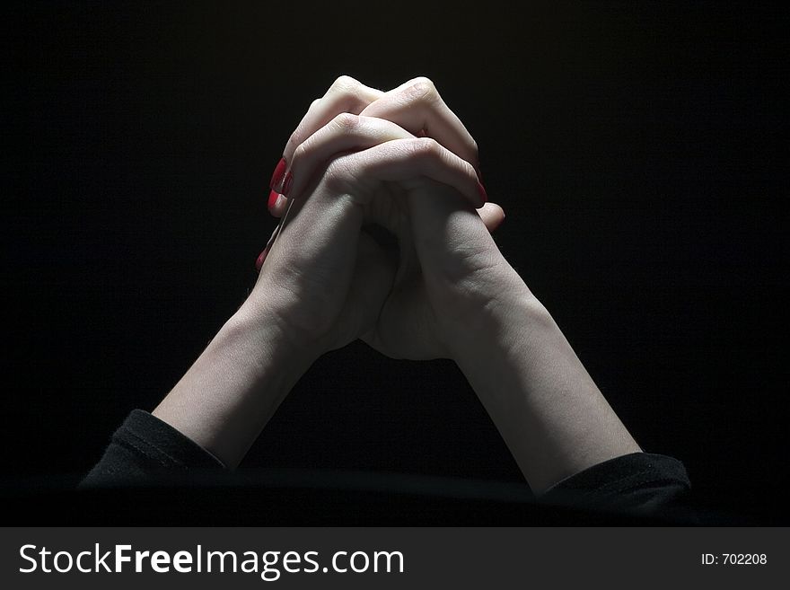 Tie palms with cross fingers in dark background. Tie palms with cross fingers in dark background