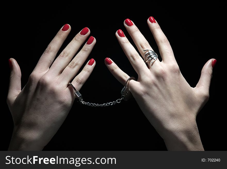 Palms tie with handcuffs in dark background. Palms tie with handcuffs in dark background