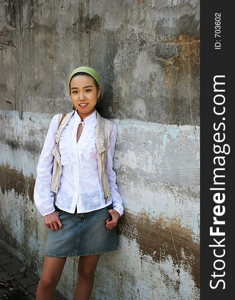 Beautiful Asian woman wearing a white shirt and denim skirt. Beautiful Asian woman wearing a white shirt and denim skirt