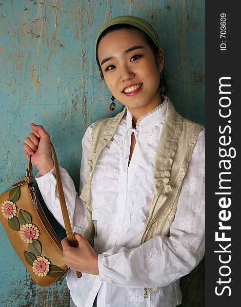 Asian woman holding a handbag