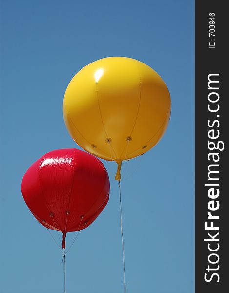 Two coloured balloons flying high