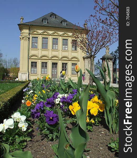 An historic building with some spring flowers in front. An historic building with some spring flowers in front