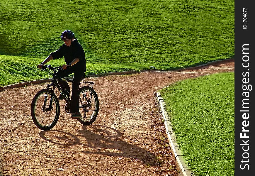 Cyclist on hillside in early summer / late spring