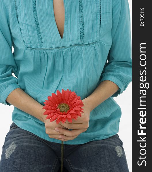 Girl on turquoise shirt holding a red flower. Girl on turquoise shirt holding a red flower