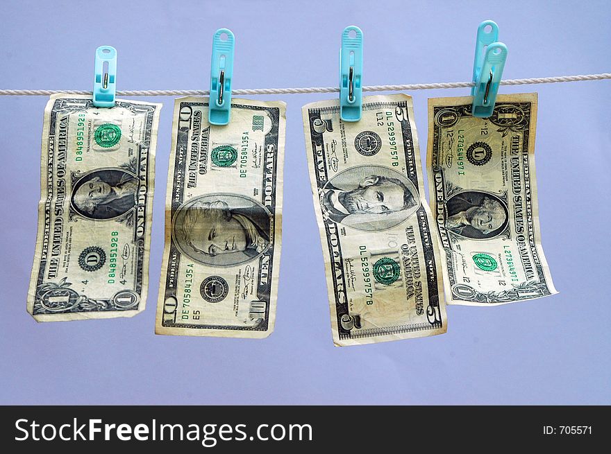 USA or American currency on a laundry (wash) line with blue background. USA or American currency on a laundry (wash) line with blue background