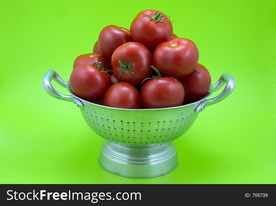 Isolated colander with tomatoes