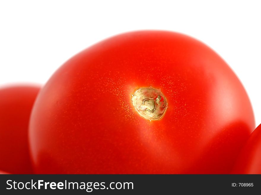 A big orange-red tomato among tomatoes. A big orange-red tomato among tomatoes