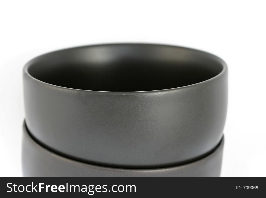 Two stacked black bowls with a smooth, very black interior