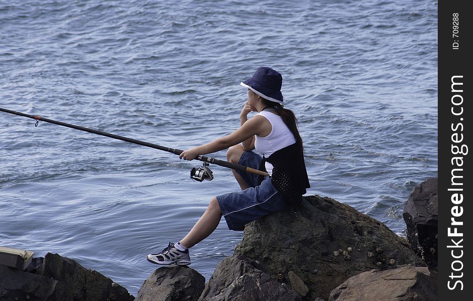 Image of a young lady fishing. Image of a young lady fishing