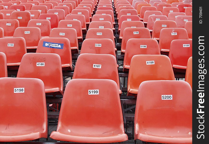 Not created abstractions, curves, lines, patterns here chairs prepared for an outdoor concert. Not created abstractions, curves, lines, patterns here chairs prepared for an outdoor concert