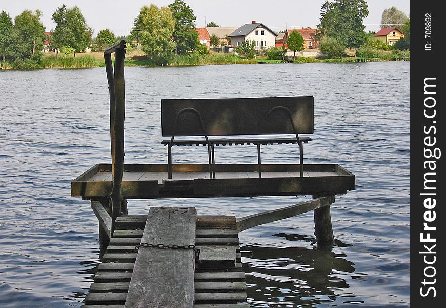 Fishing pier at lake near village. Fishing pier at lake near village.