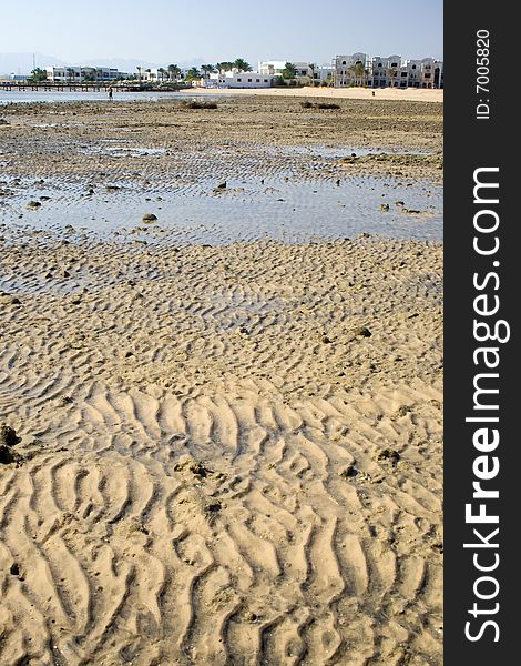 The tide is out at this deserted morning beach on the resort strip in Hurghada, Egypt