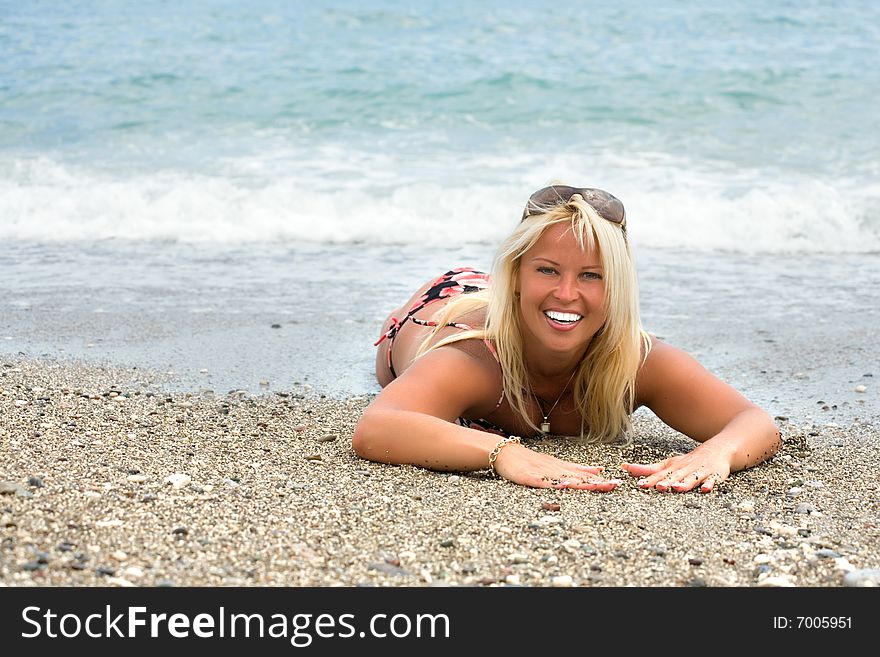 Beautiful woman in a bikini on the beach. Beautiful woman in a bikini on the beach