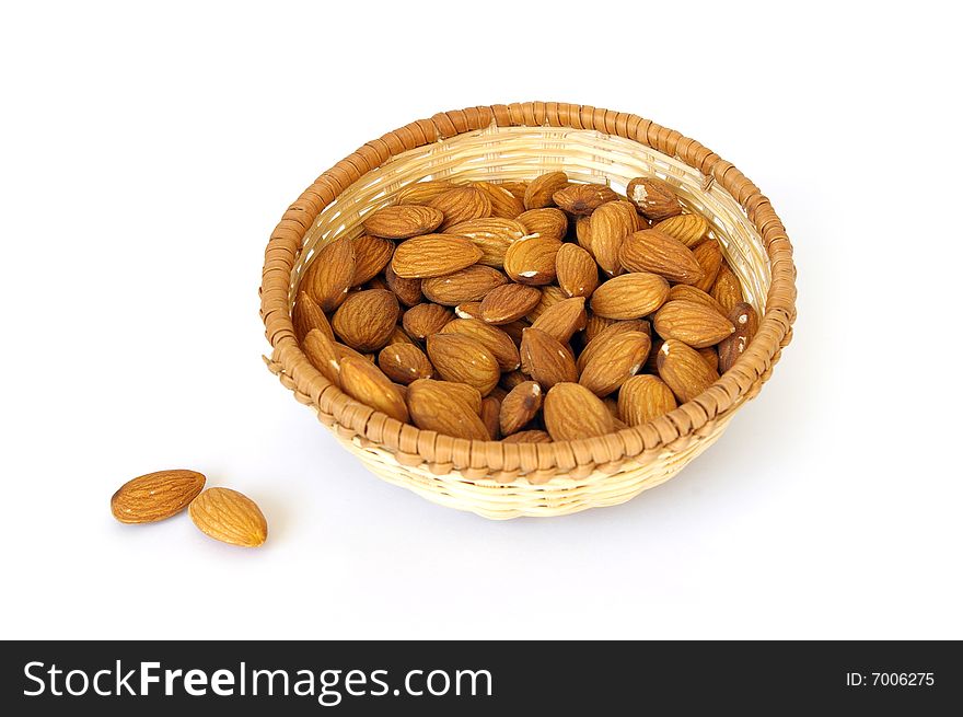 Basket of almonds isolated on white background