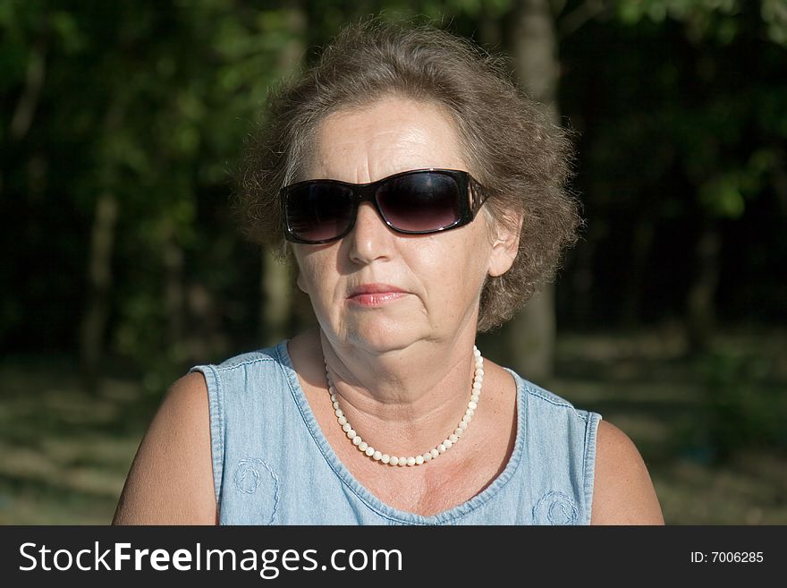 Gracious senior lady portrait in garden