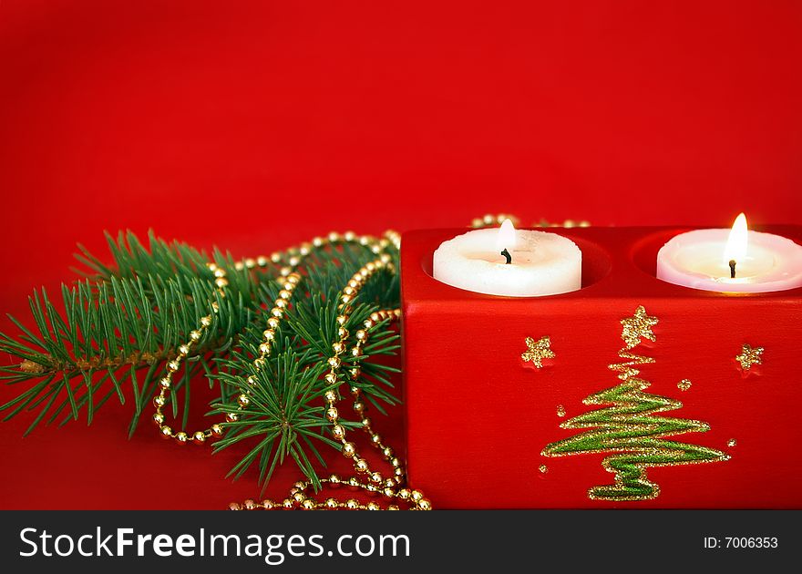 Christmas card. Candle and decoration isolated on red. Christmas card. Candle and decoration isolated on red