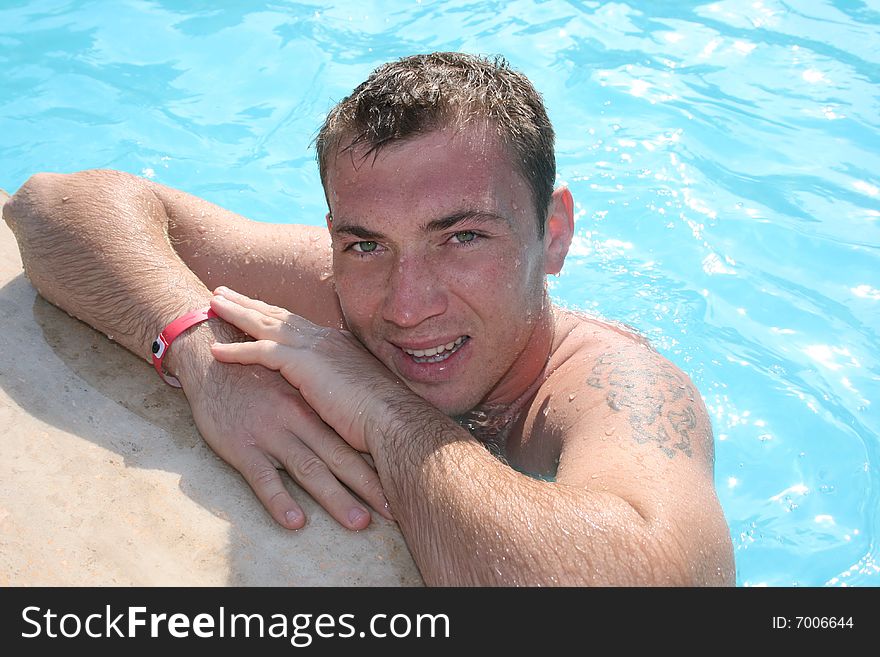 The guy floats in pool. The guy floats in pool