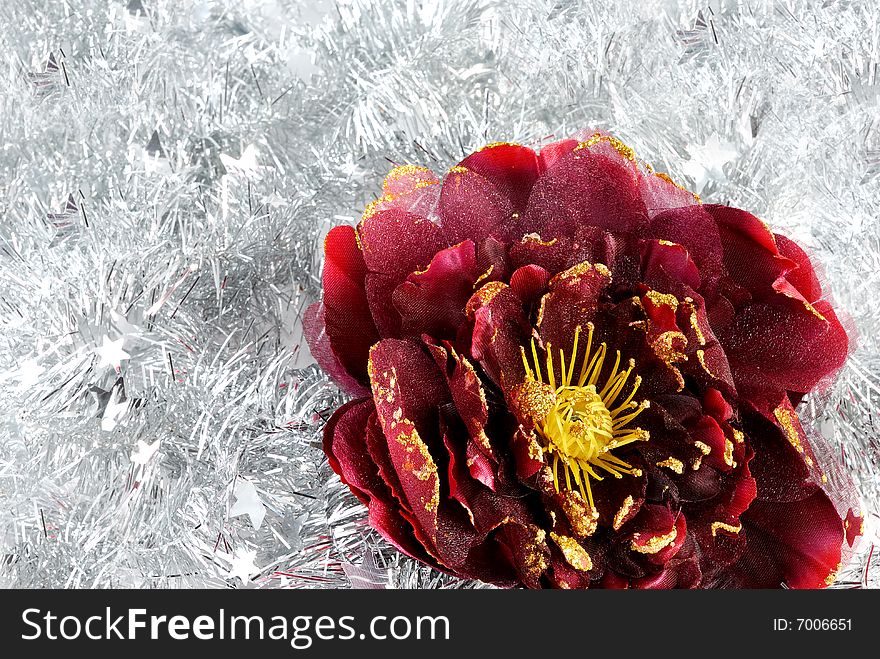 Christmas red flower decorations on silver tinsel. Christmas red flower decorations on silver tinsel