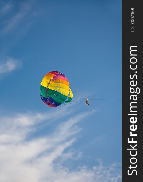 Man is parasailing in the blue sky