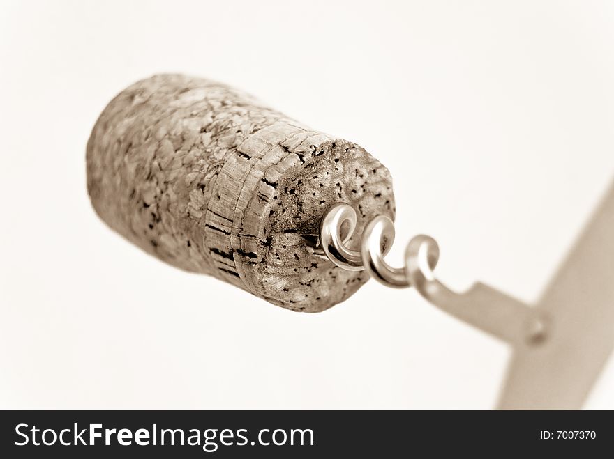 Wine cork on the bottle opener- selective focus,isolated on light sepia background