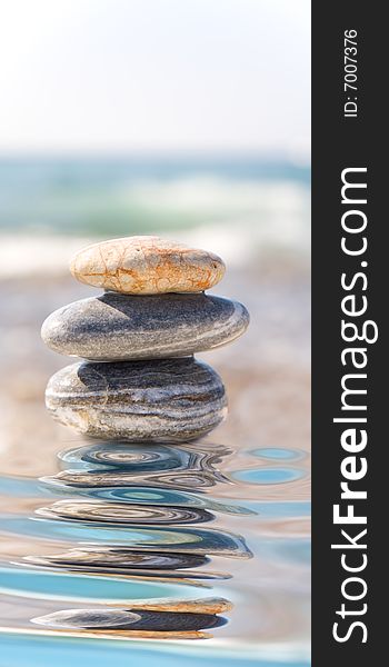 Stack of pebbles on sea background