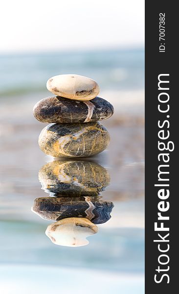 Stack of pebbles on sea background