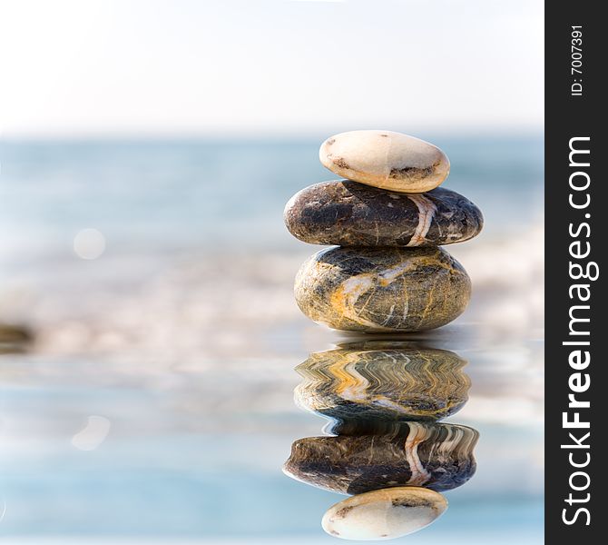 Stack of pebbles on sea background