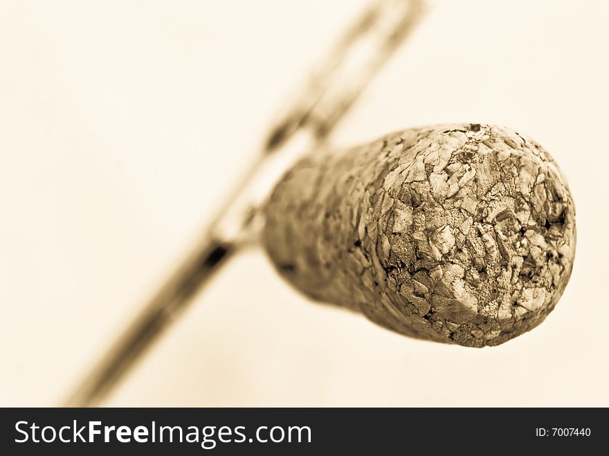 Wine cork on the bottle opener- selective focus,isolated on light sepia background