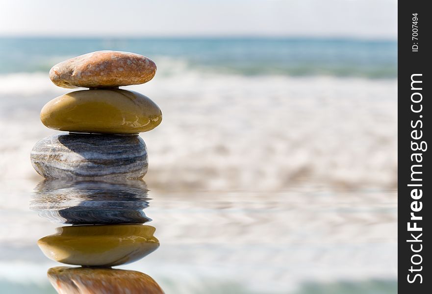 Stack of pebbles on sea background