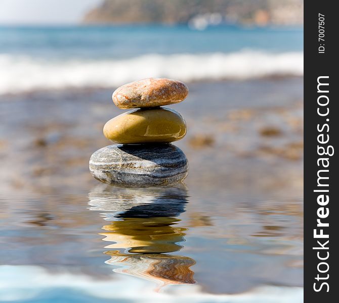 Stack of pebbles on sea background