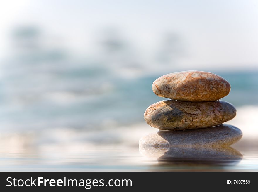 Stack of pebbles on sea background