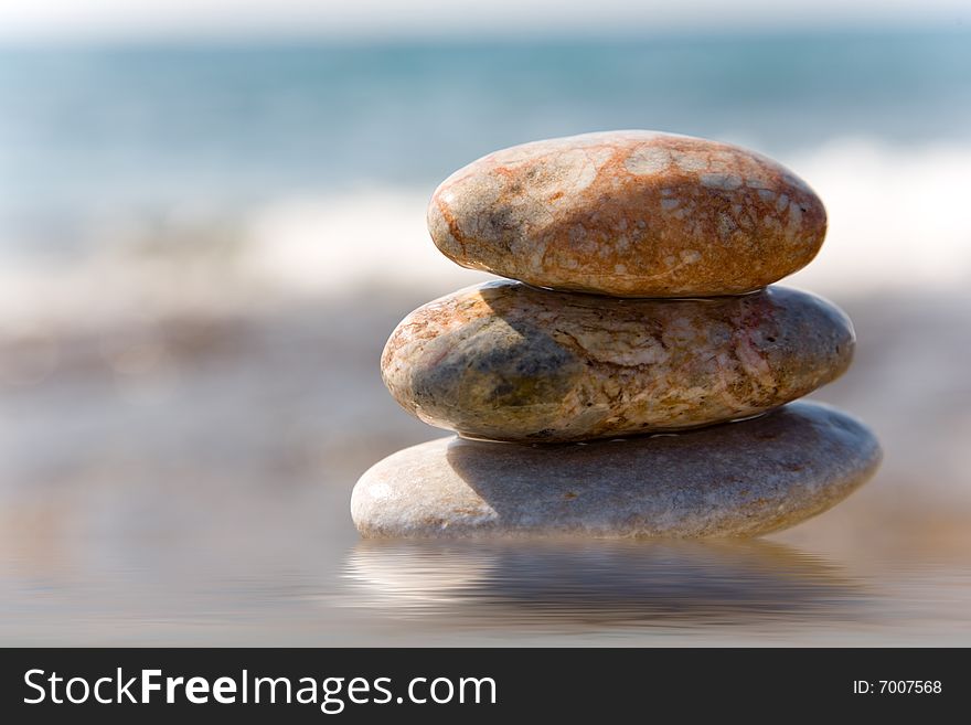 Stack of pebbles on sea background