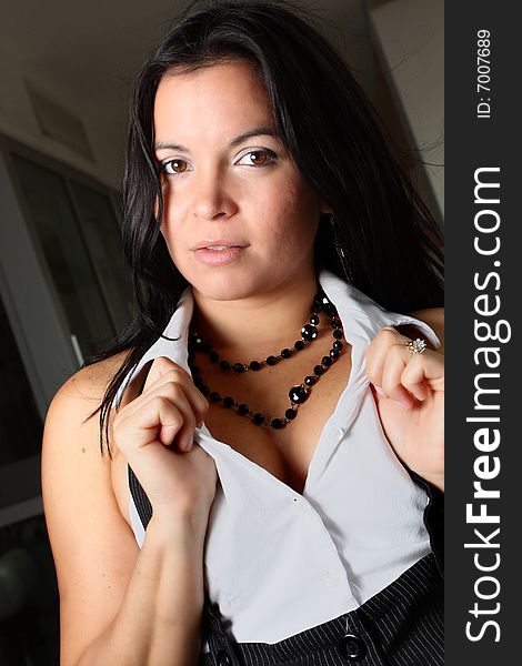 Young woman posing and holding her collared shirt. Young woman posing and holding her collared shirt