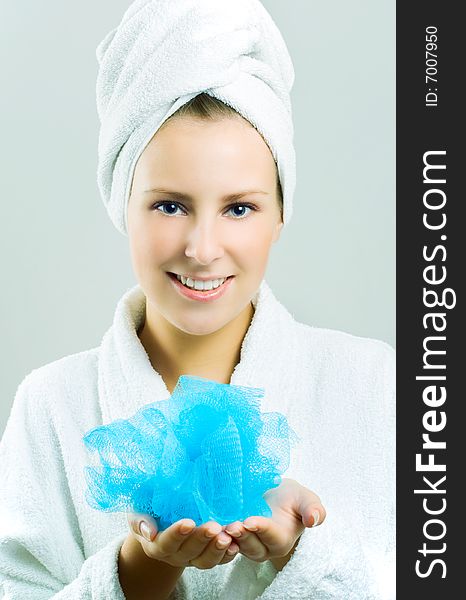 Beautiful girl with blue bath sponge.