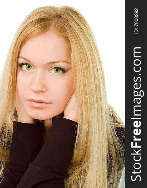 Young attractive green-eyed dreaming woman in black on white background