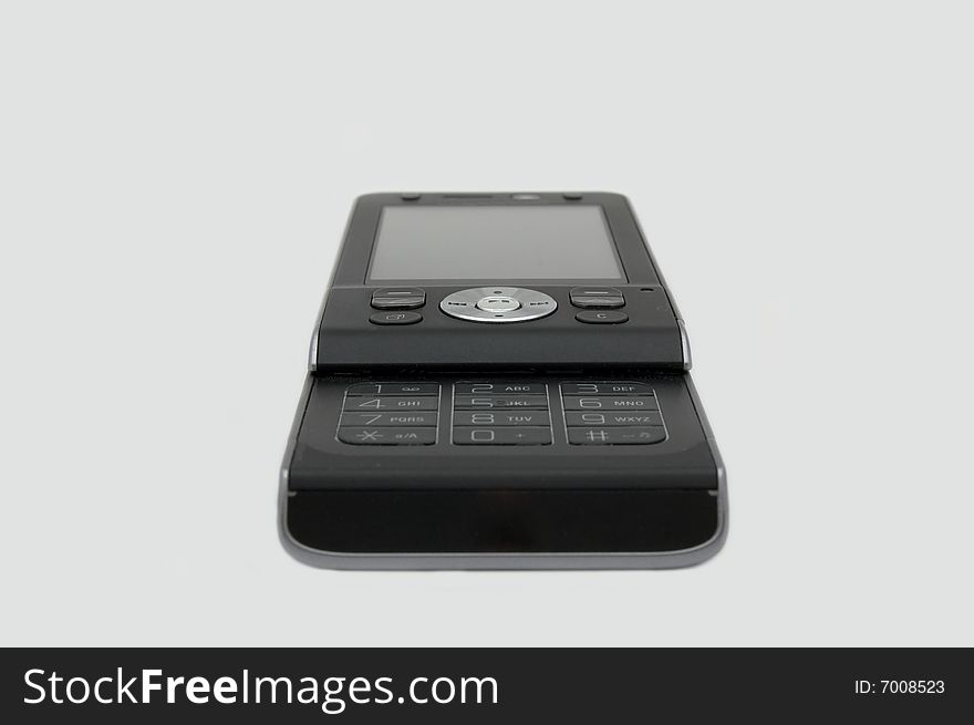 Small black mobile phone isolated on background