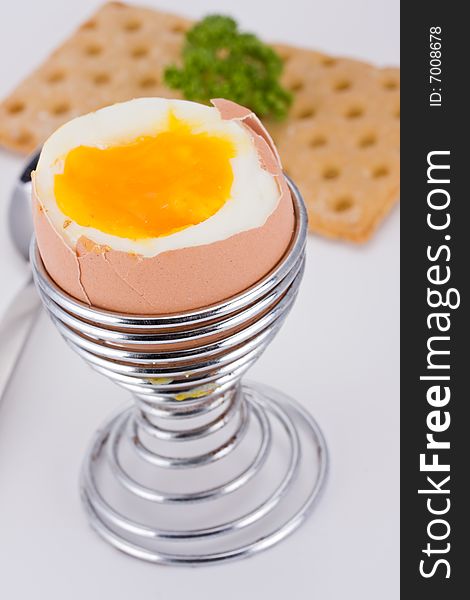 Brown egg in an eggcup and crispbread. Brown egg in an eggcup and crispbread