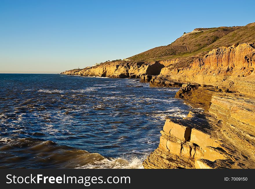 Cliffs next to the Pacific Ocean with tidepools on a clear day. Cliffs next to the Pacific Ocean with tidepools on a clear day.