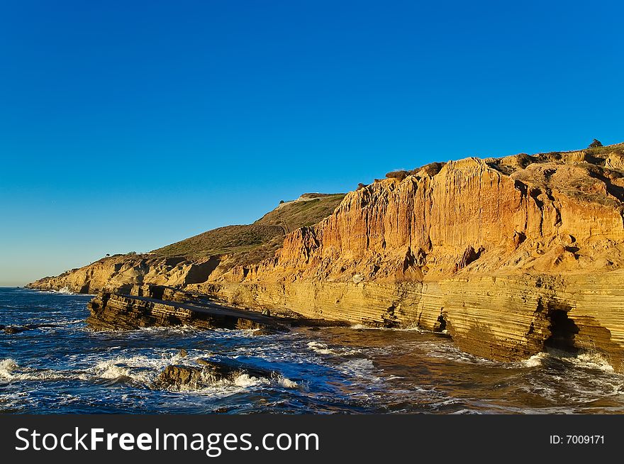 Cliffs next to the Pacific Ocean with tidepools on a clear day. Cliffs next to the Pacific Ocean with tidepools on a clear day.