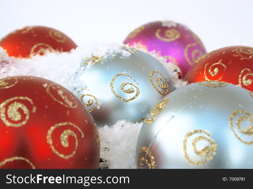 Christmas colorful balls in the snow.Focus on the middle ball.