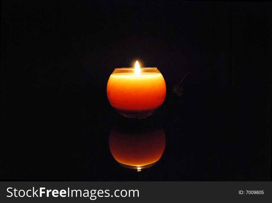 A candle with black background