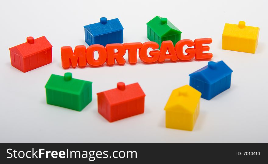 Toy houses surrounding the word Mortgage. Toy houses surrounding the word Mortgage