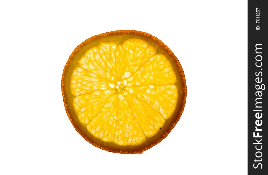 A backlit piece of sliced orange - healthy eating